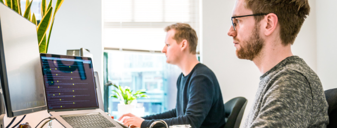 men working in the office on laptops